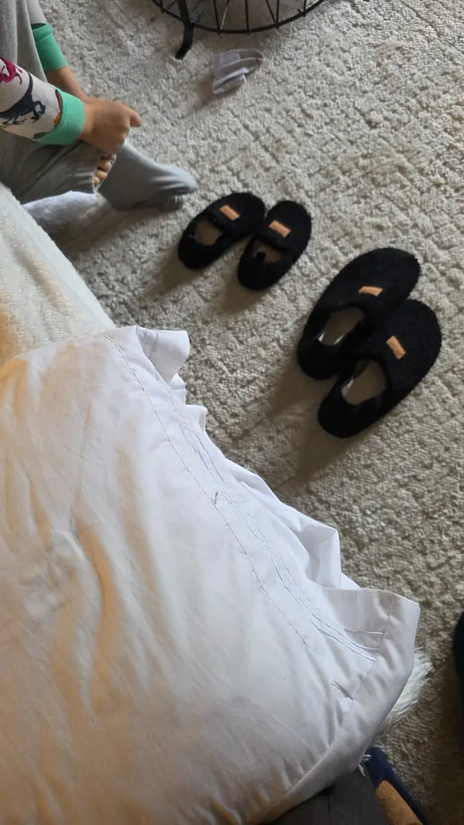 Washable black house shoes kept indoors for everyday family use